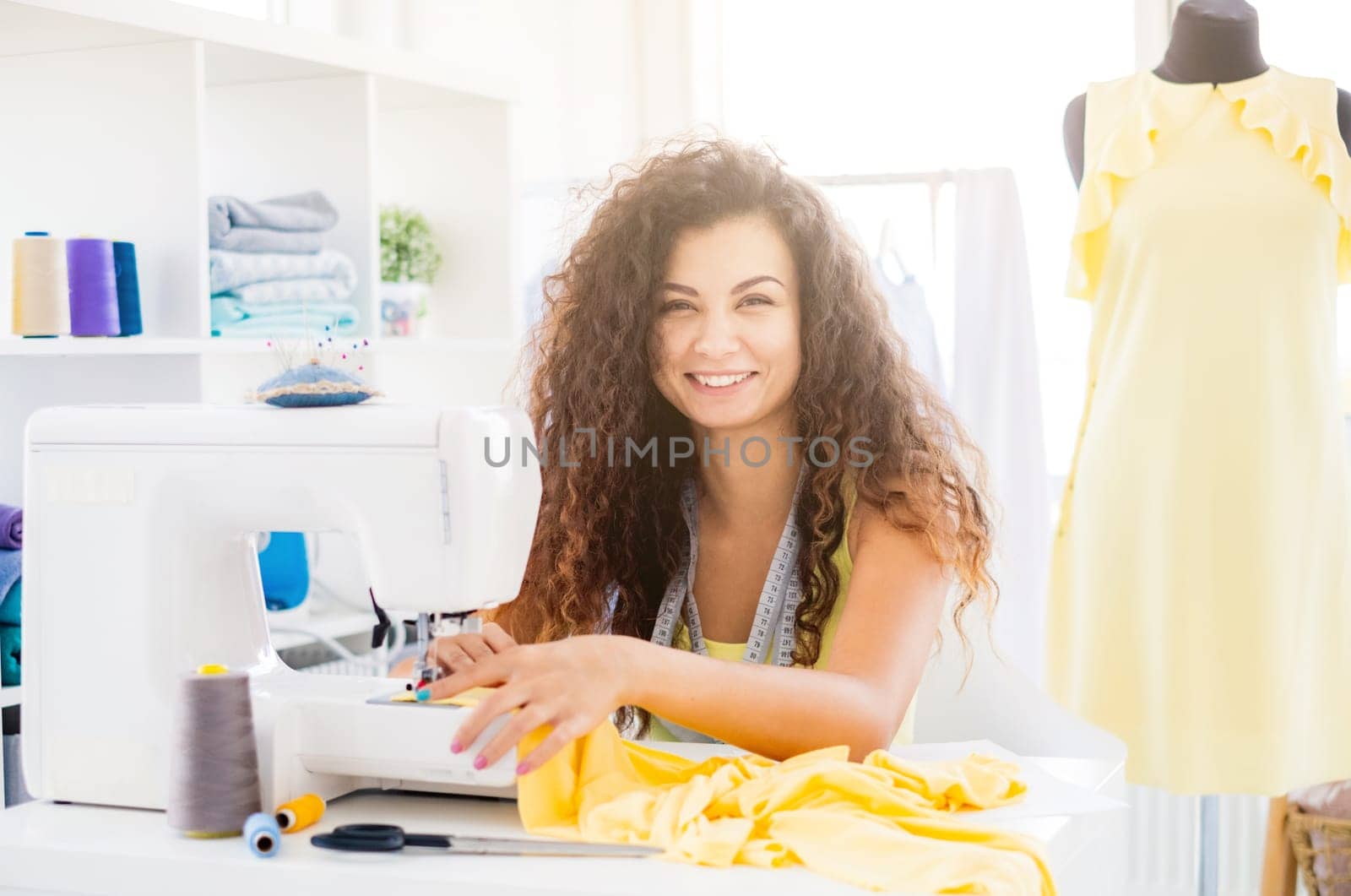 Seamstress working on sewing machine by GekaSkr