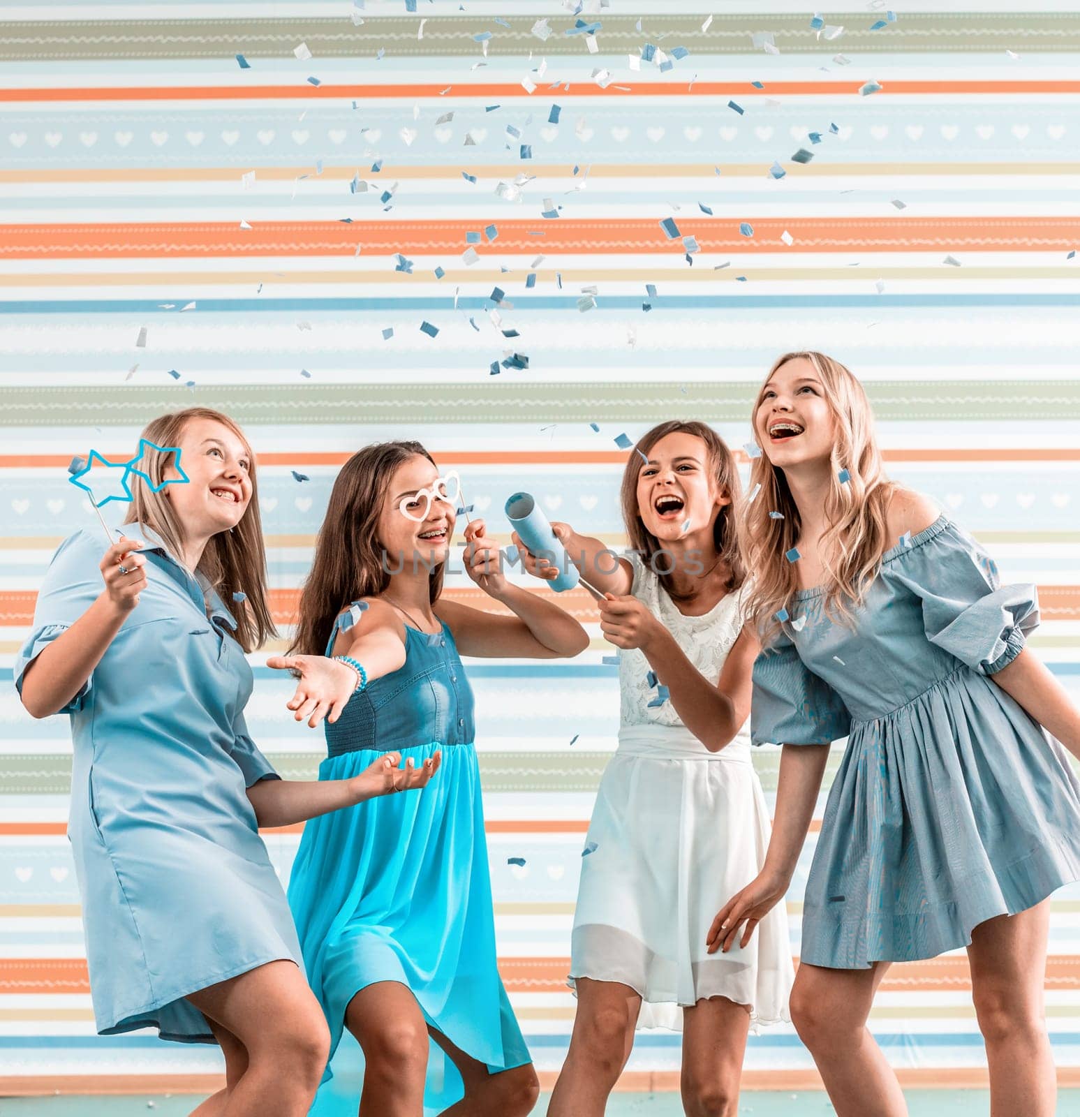 Smiling girls shoot confetti by GekaSkr
