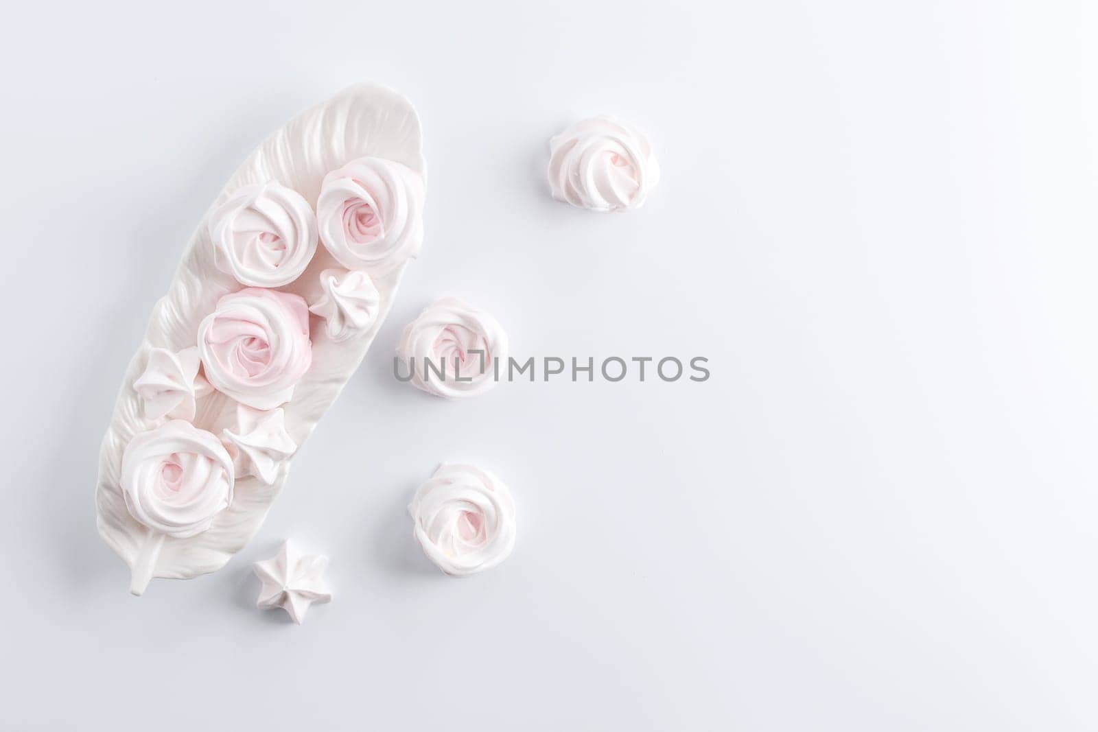 Meringue. Light dessert of whipped egg whites on a white background. copy space