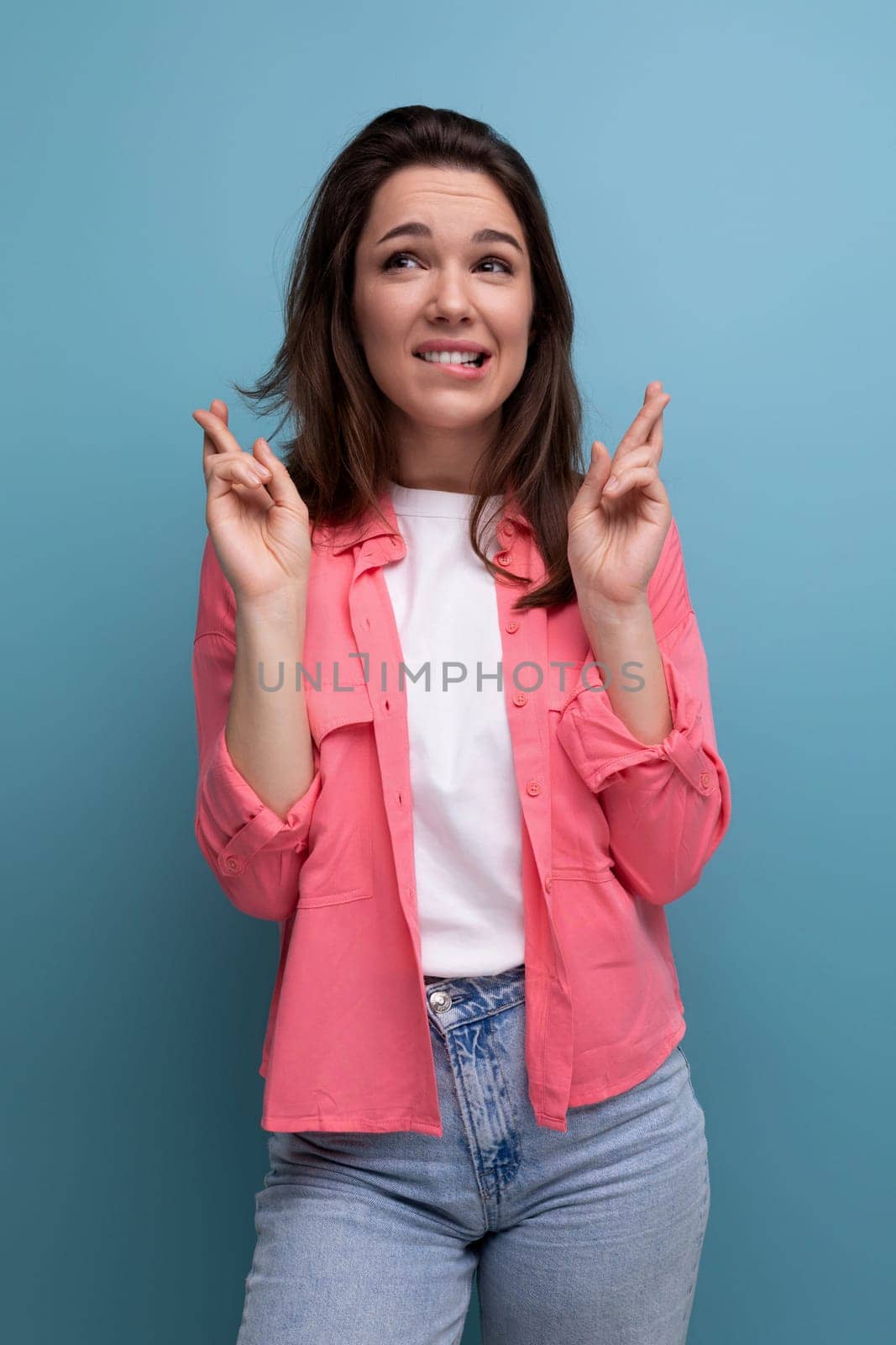 portrait of a dreamy cute brunette young woman in a stylish image in the studio by TRMK