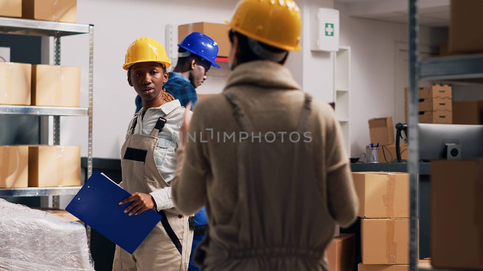 Multiethnic group of people in overalls checking goods by DCStudio