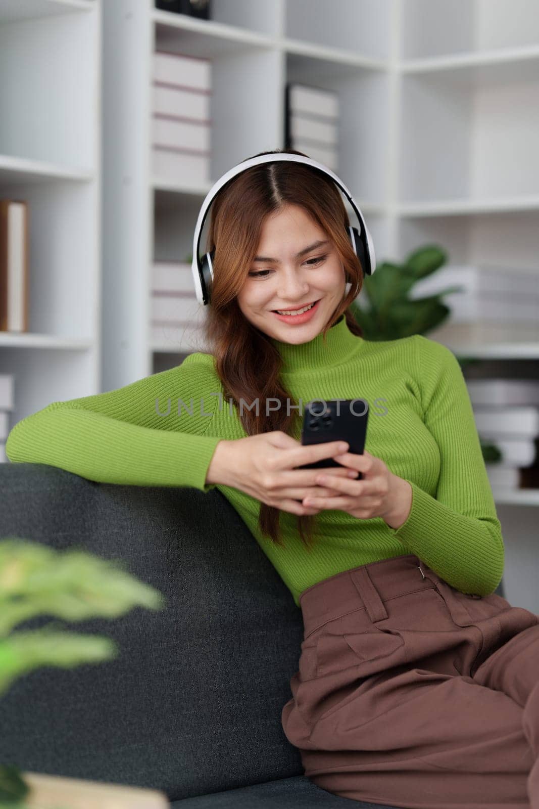 Attractive Asian woman resting comfortable living room and using mobile phone, Relax, Sofa, Lifestyle.