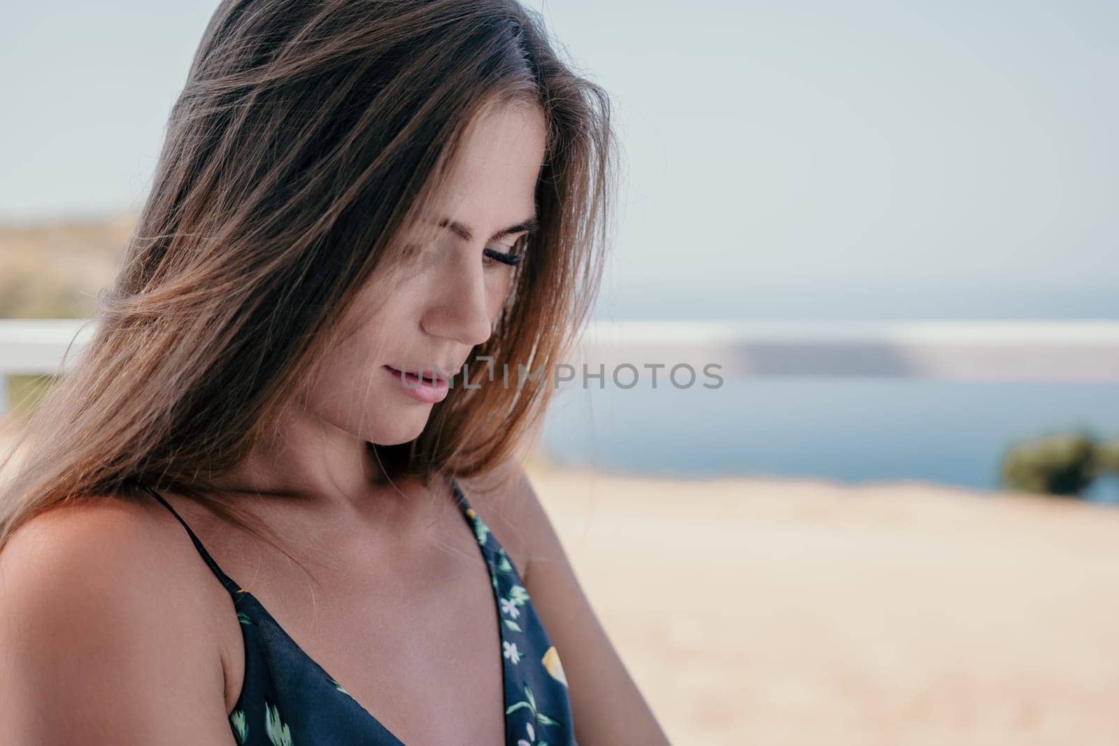 Happy woman portrait in cafe. Boho chic fashion style. Outdoor photo of young happy woman with long hair, sunny weather outdoors sitting in modern cafe. by panophotograph