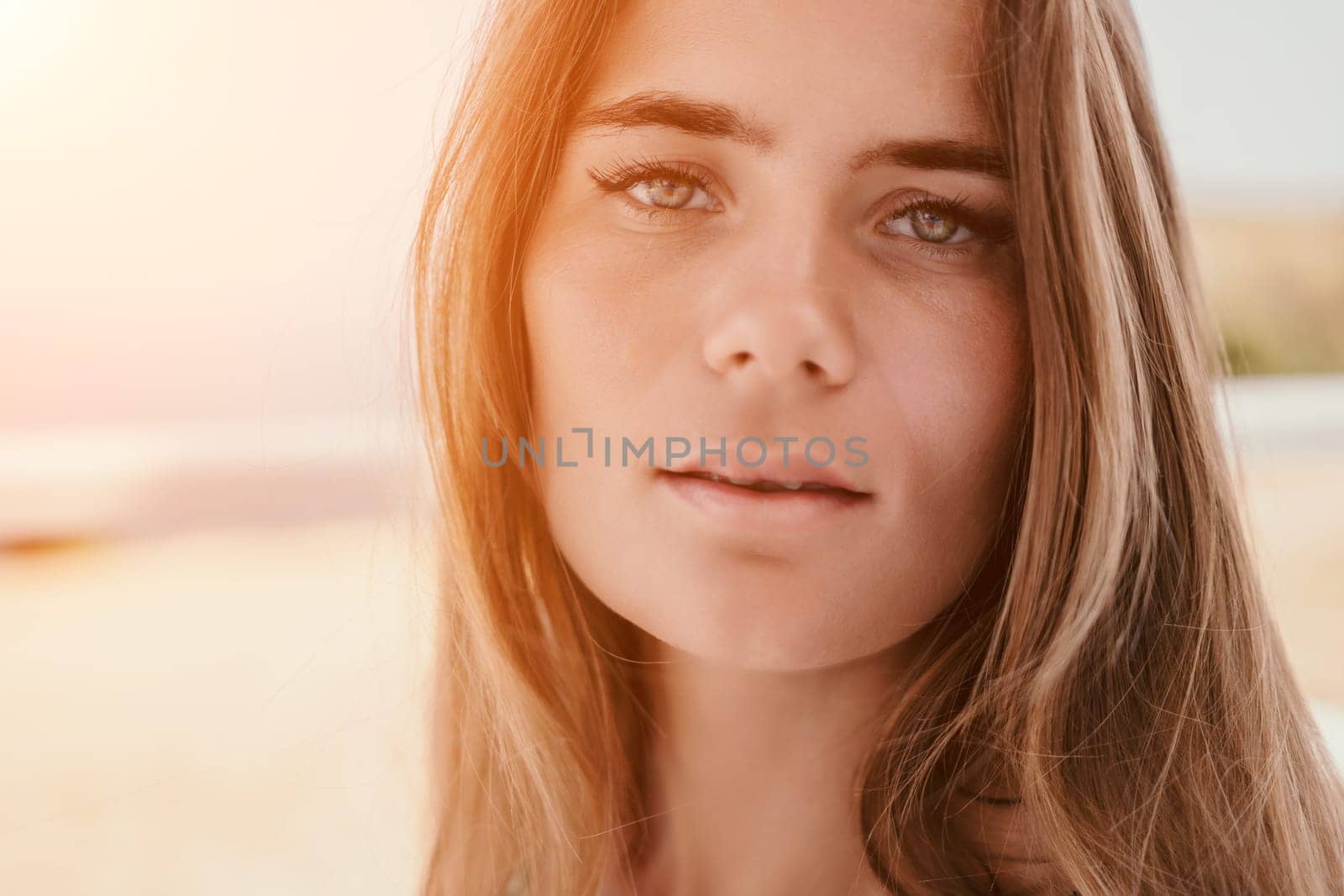 Happy woman portrait in cafe. Boho chic fashion style. Outdoor photo of young happy woman with long hair, sunny weather outdoors sitting in modern cafe