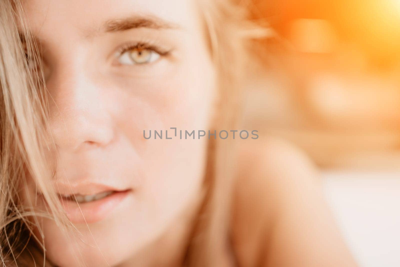 Happy woman portrait in cafe. Boho chic fashion style. Outdoor photo of young happy woman with long hair, sunny weather outdoors sitting in modern cafe. by panophotograph