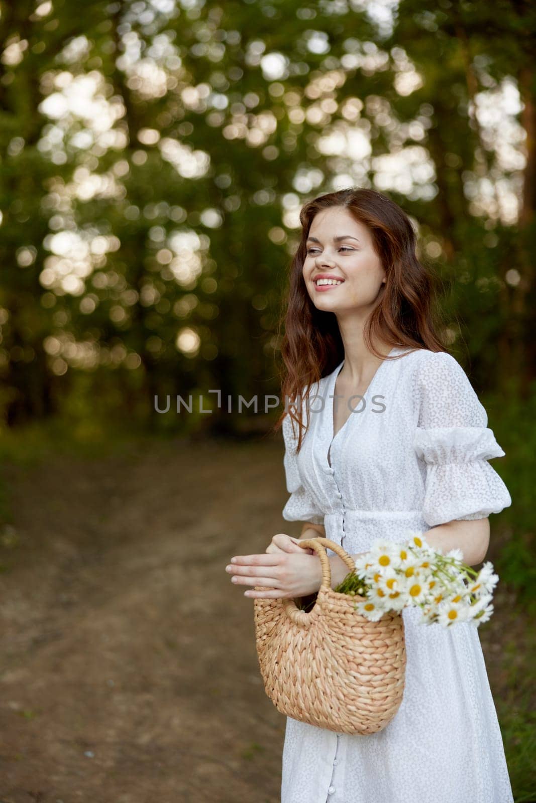 portrait of a beautiful red-haired woman with a wicker bag in her hands, smiling, enjoying a walk in the park. High quality photo