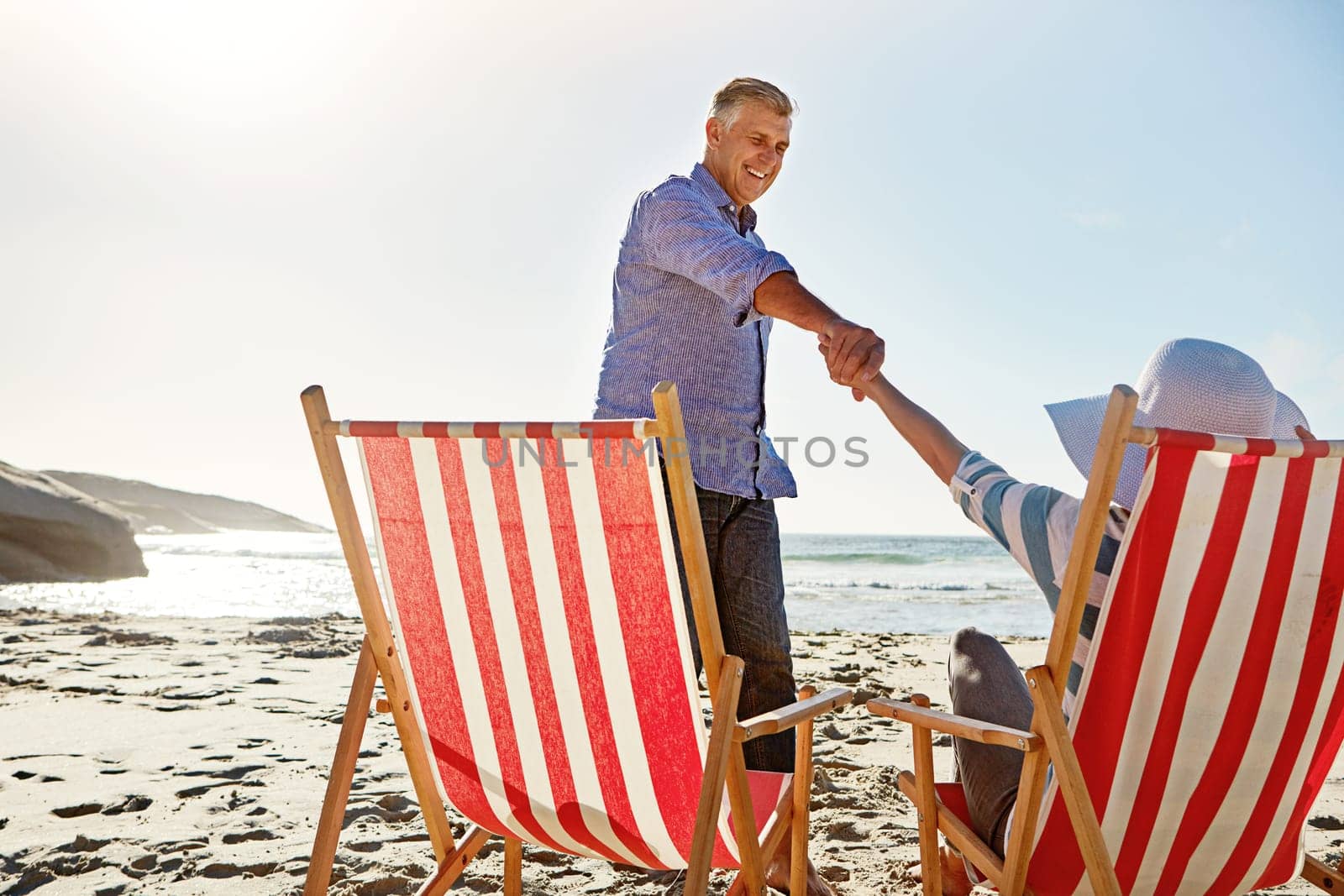Let me show you the beauty out there. a mature couple spending the day at the beach