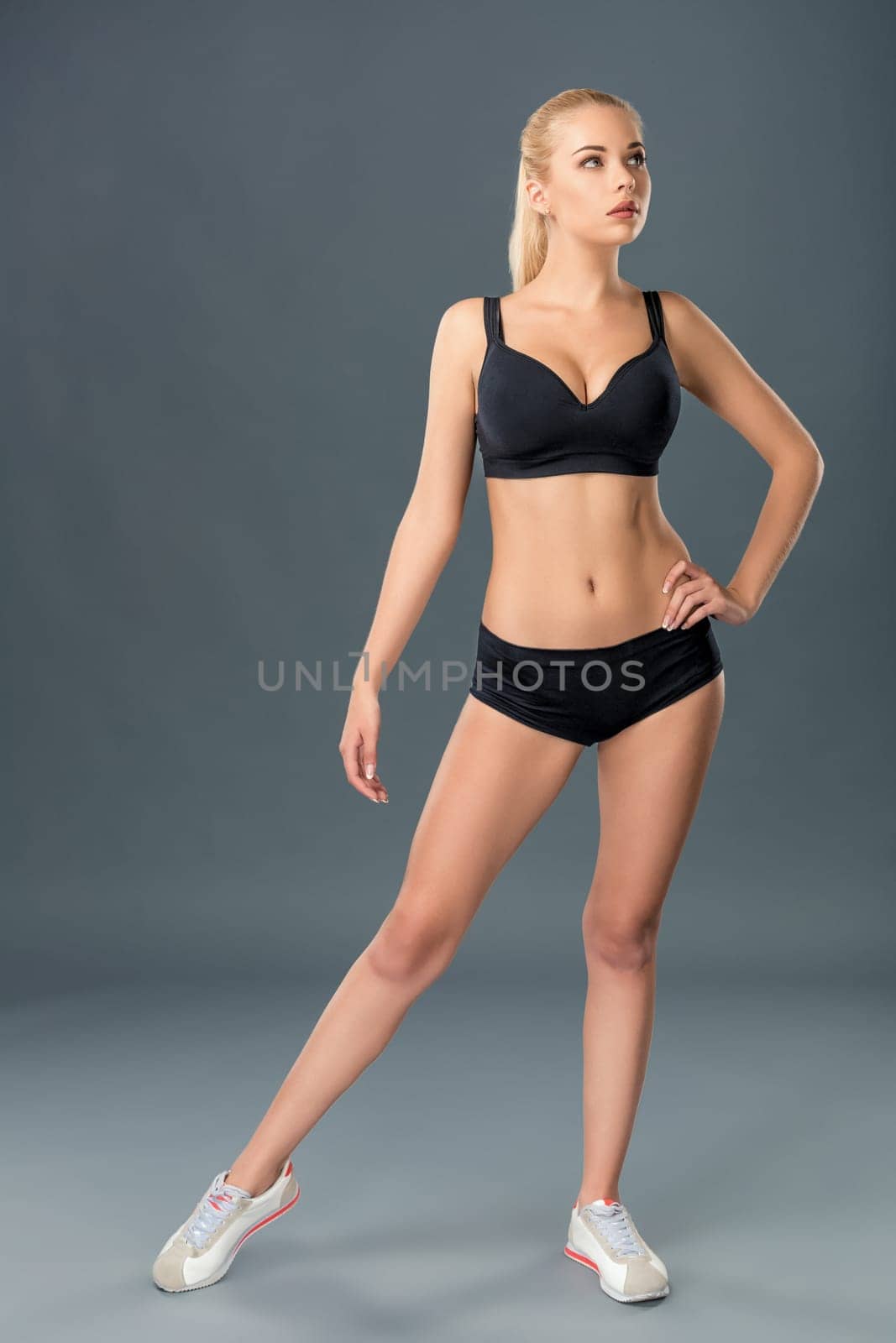 Young beautiful woman in fitness wear trained female body, lifestyle portrait, caucasian model