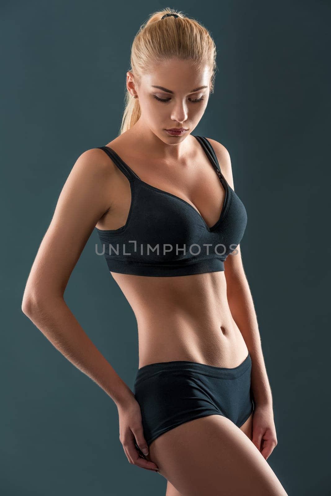 Young beautiful woman in fitness wear trained female body, lifestyle portrait, caucasian model