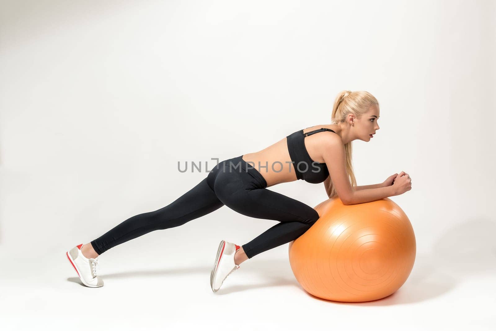 Young blonde woman training with fitball. Fitness exercises