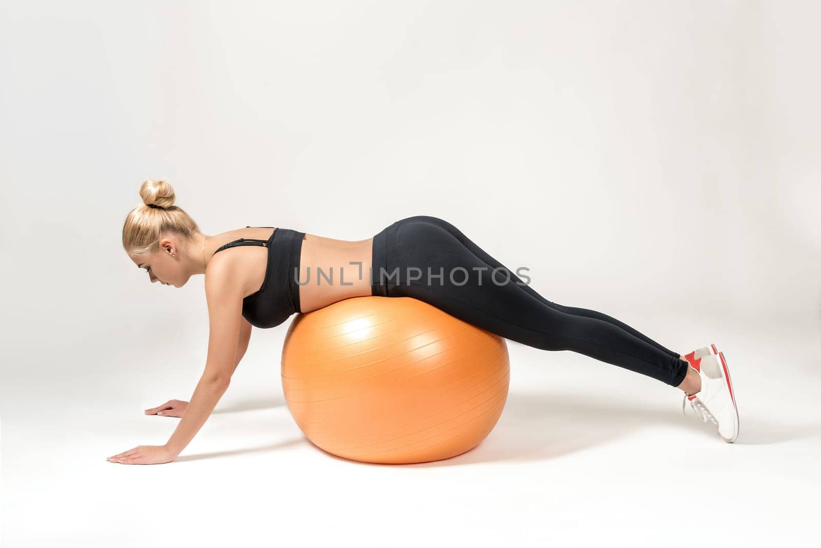 Young blonde woman training with fitball. Fitness exercises