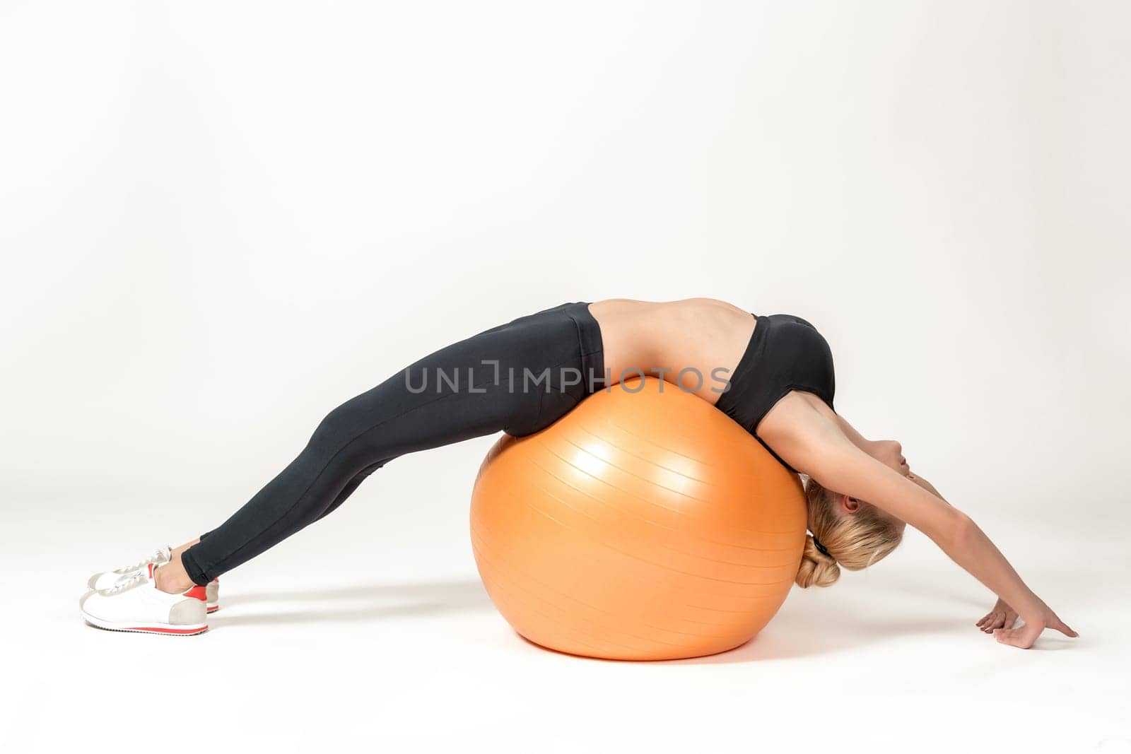 Young blonde woman training with fitball. Fitness exercises