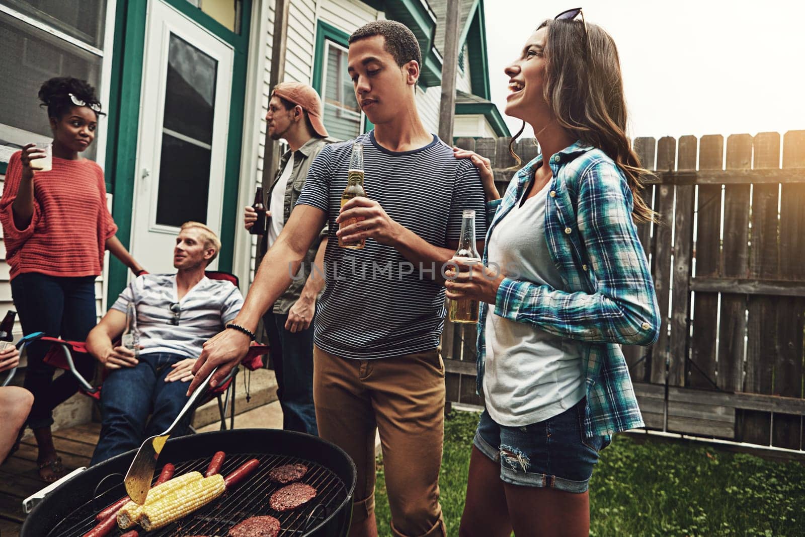 Summer is a season best shared. a group of friends having a barbecue in the yard