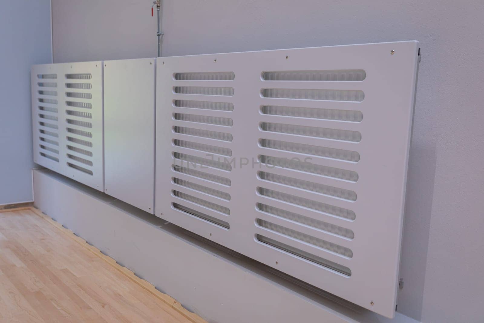 Installed typical system covers provided for sports hall radiators.