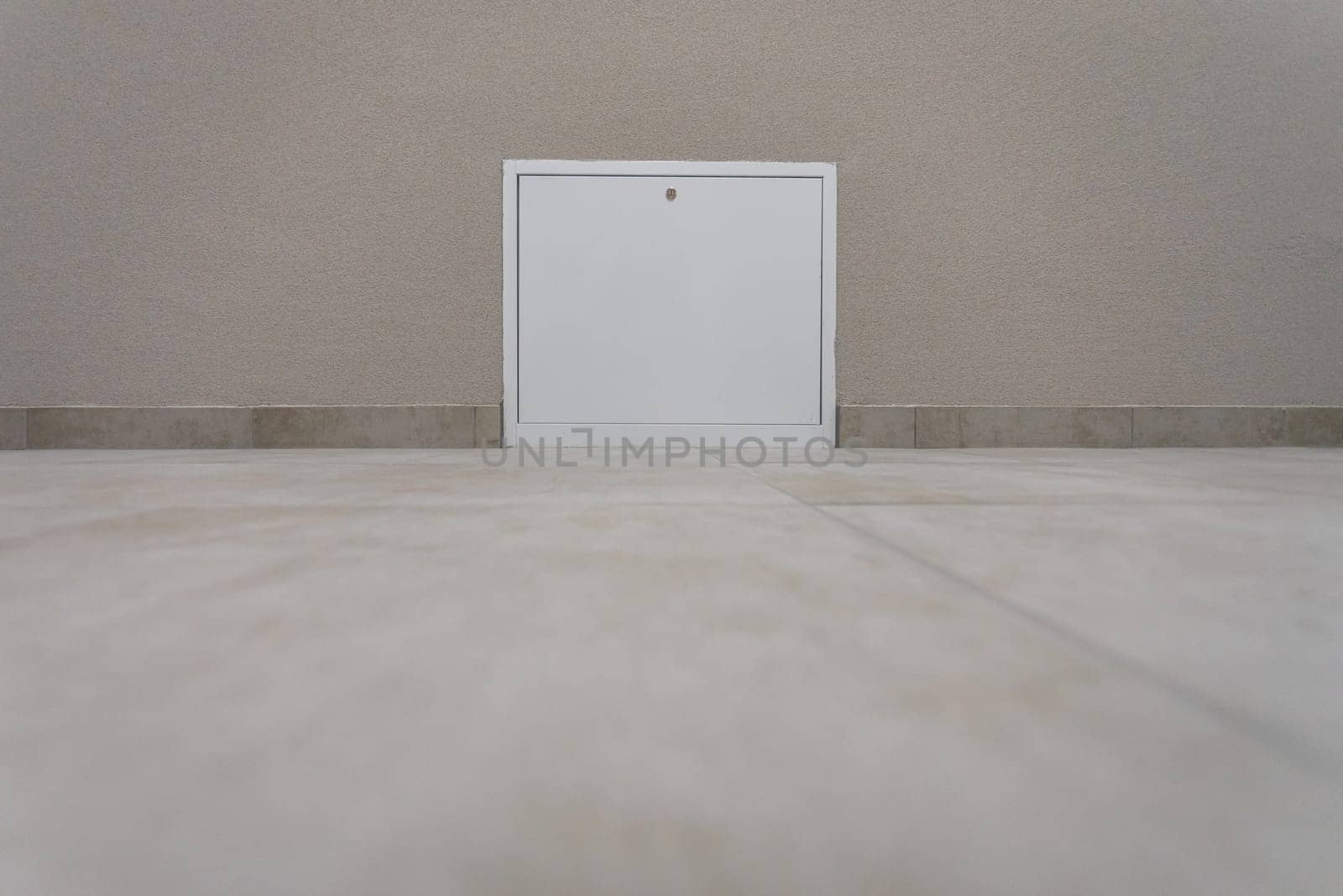 Right at the floor itself are installed white inspection doors for heating or water installation. View at the very floor.