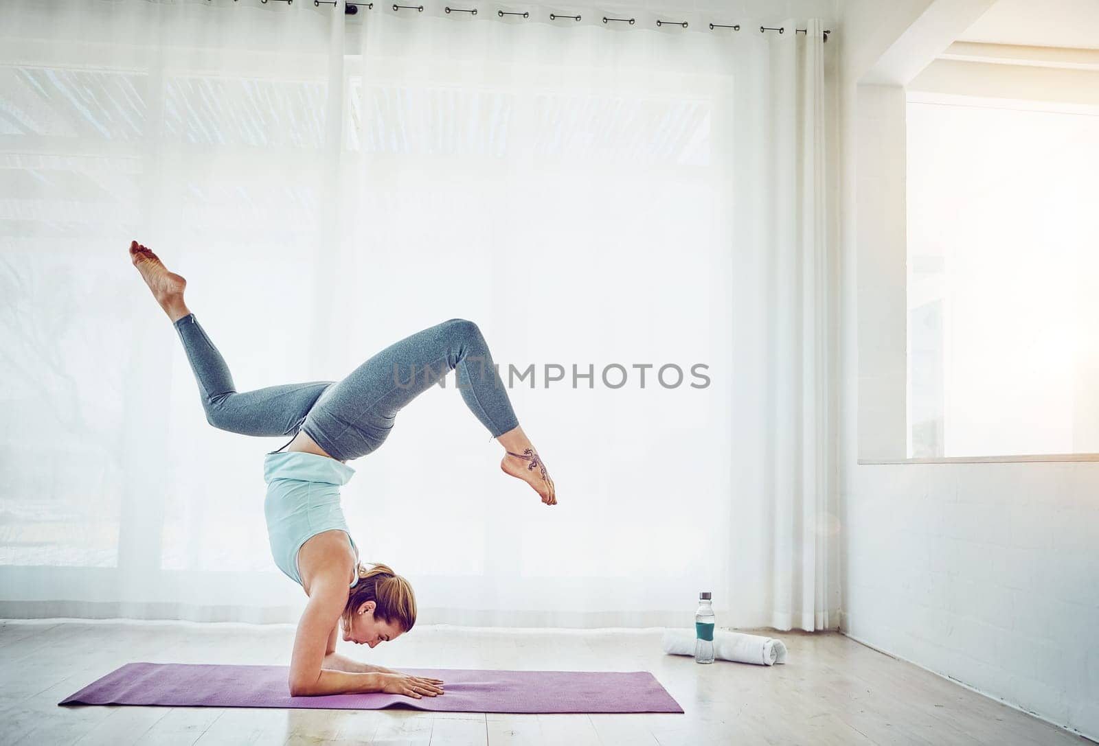 Yoga was made for me. an attractive woman practising her yoga routine at home. by YuriArcurs
