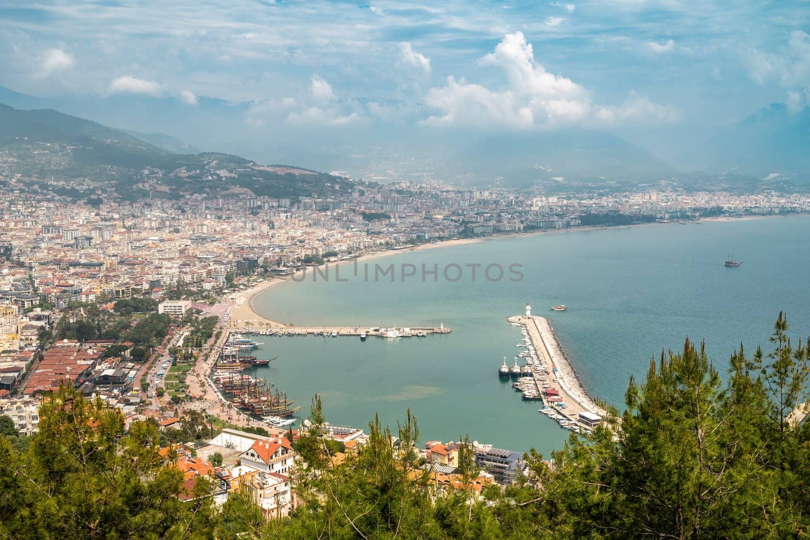 Aerial view of Alanya marina and city on a cloudy day by Sonat