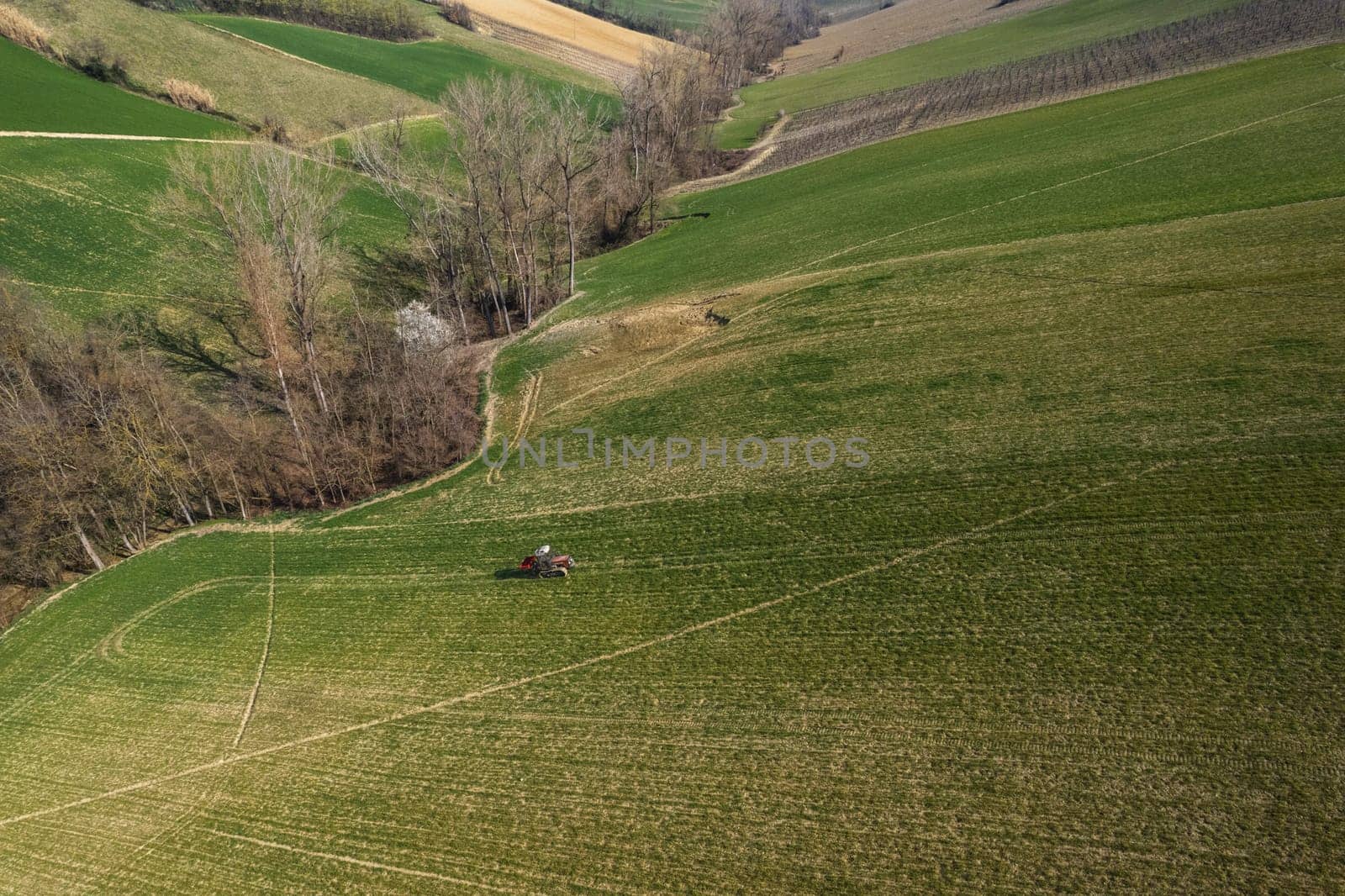 farmer driving uphill crawled tractor in the farm during spring season