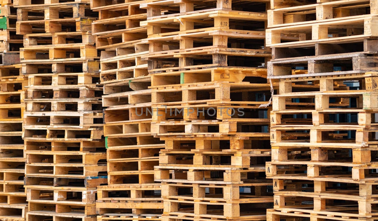 Stack of wooden pallet. Industrial wood pallet at factory warehouse. Cargo and shipping concept. Sustainability of supply chains. Eco-friendly nature and sustainable properties. Renewable wood pallet. by Fahroni
