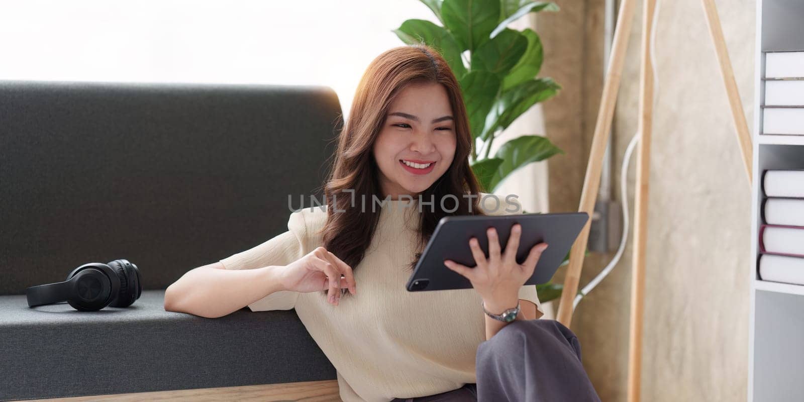 Attractive Asian woman resting comfortable living room and using digital tablet, Relax, Sofa, Lifestyle.
