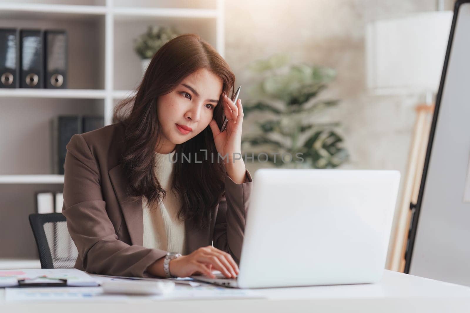Accountant woman working on laptop and do document look stress, tax, exchange, research, accounting and Financial advisor concept.