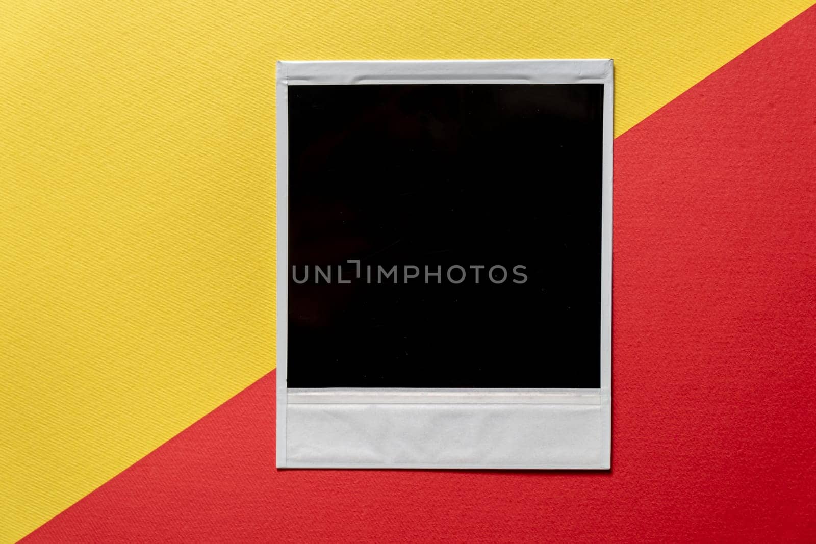 Download Blank photo frame template on red and yellow background. Blank square photo frame on wall copy space. download image