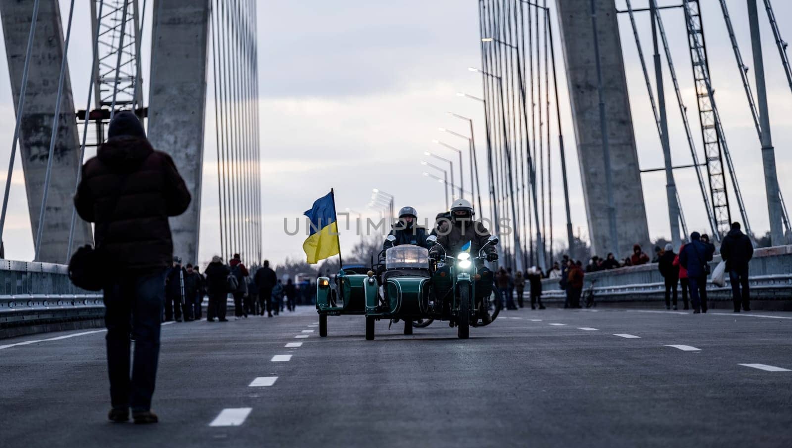 Bikers on motorcycle drive over bridge with ukraine flag. download image