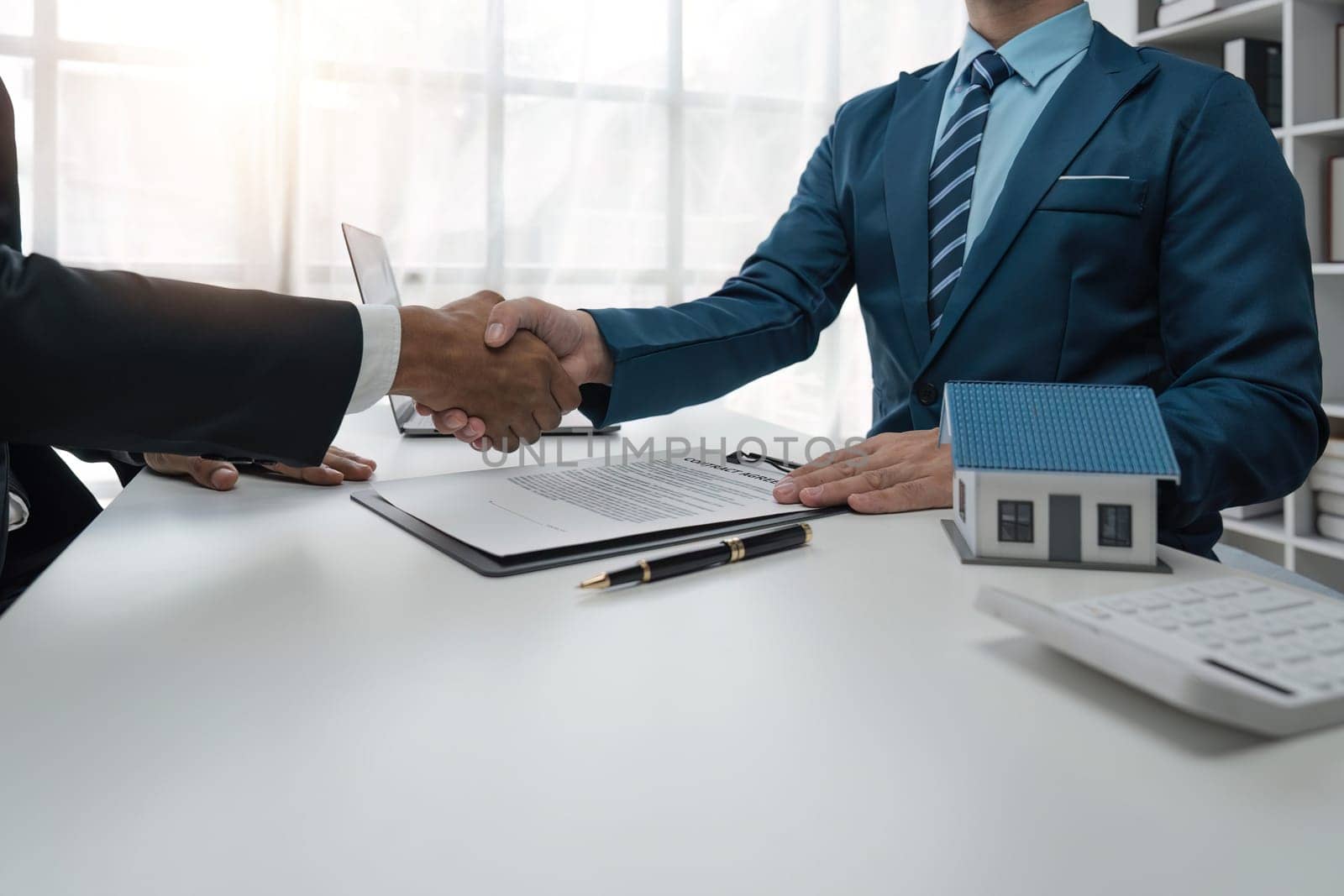 real estate agent shaking hand his client after signing contract,concept for real estate, moving home or renting property.