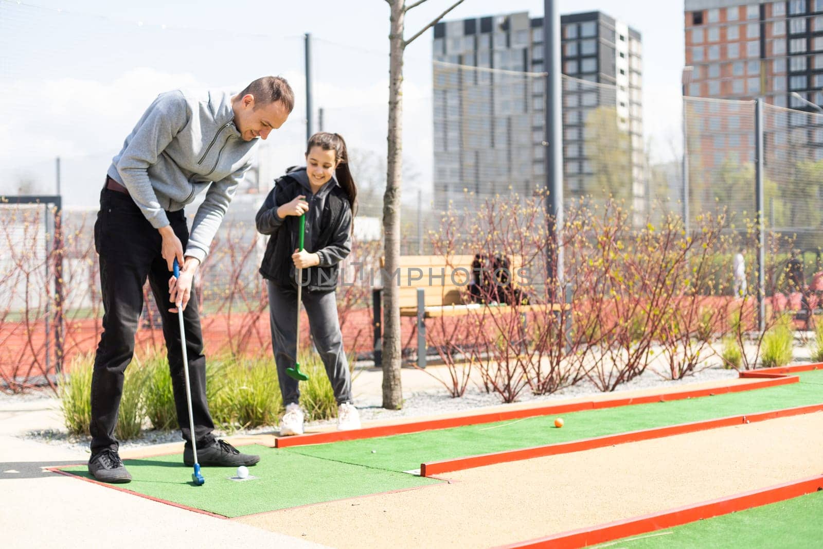 Mini-golf ball on artificial grass. Summer season game.