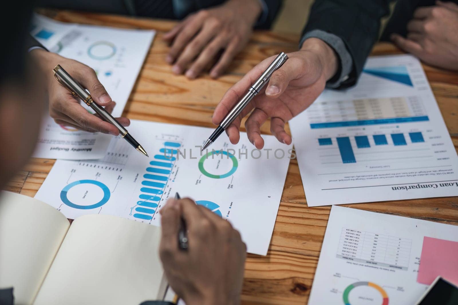 Business People Meeting using laptop computer,calculator,notebook,stock market chart paper for analysis Plans to improve quality next month. Conference Discussion Corporate Concept....