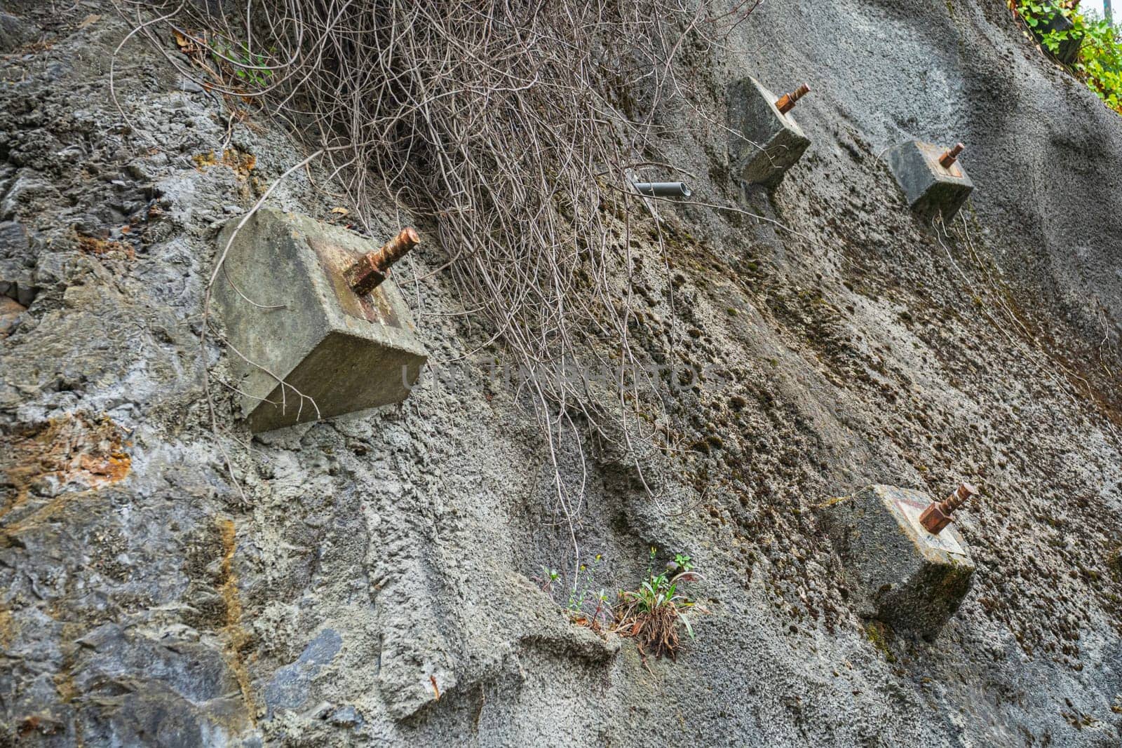 Rock bolts and Anchors to protect rock slopes from destruction. Protection of the rocky slope from collapse with reinforced concrete anchors