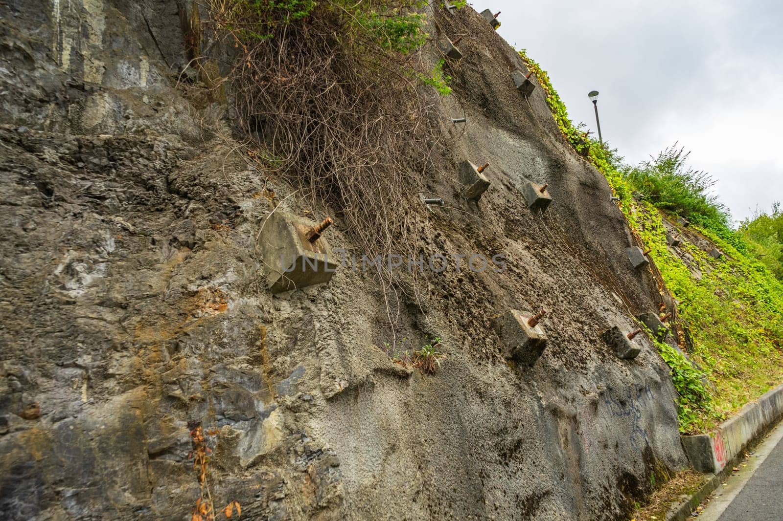 Rock bolts and Anchors to protect rock slopes from destruction. Protection of the rocky slope from collapse with reinforced concrete anchors