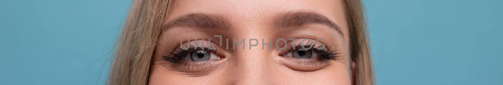 horizontal wide closeup photo of stunning female eyes in love.