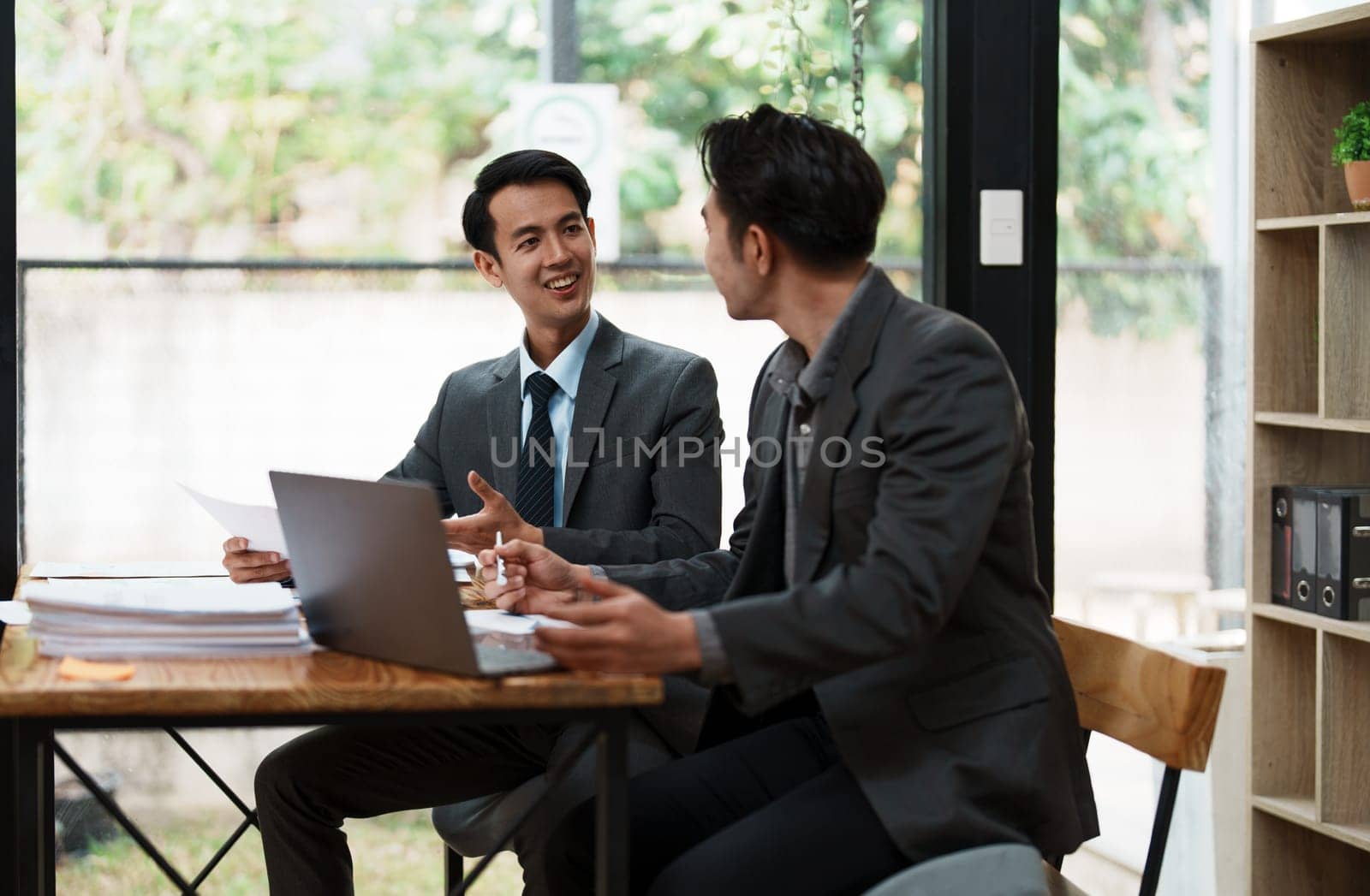 Asian business advisor meeting to analyze and discuss the situation on the financial report in the meeting room.Investment Consultant, Financial , teamwork ,brainstorming ,startup and accounting.