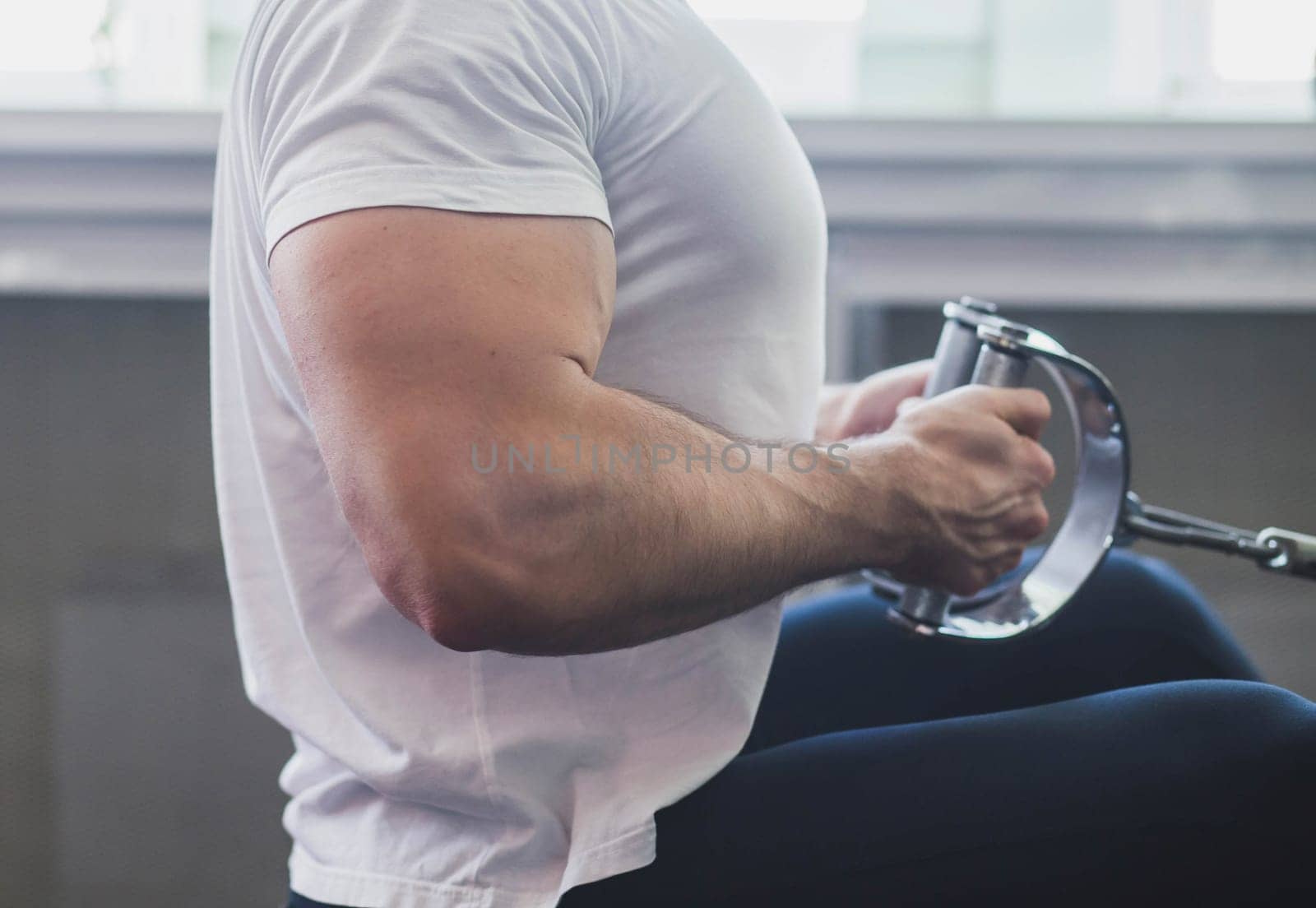 biceps of an athlete who trains in the gym, close up, focus on the arm.