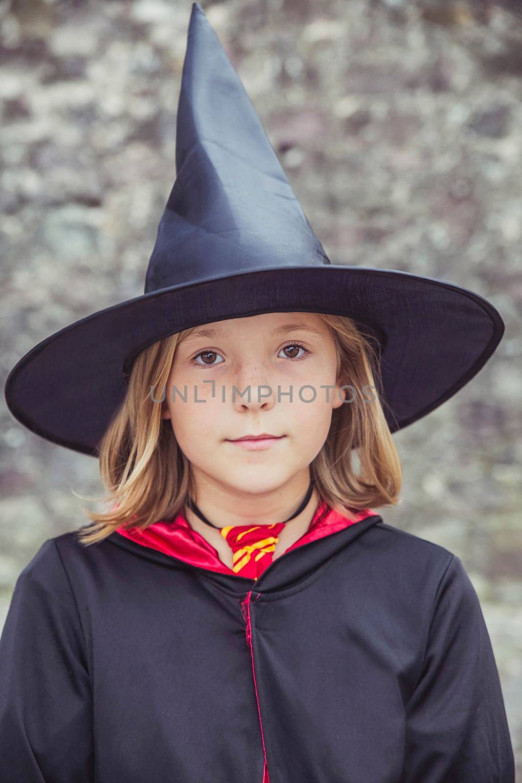 young fair-haired sorceress in mantle and hat.