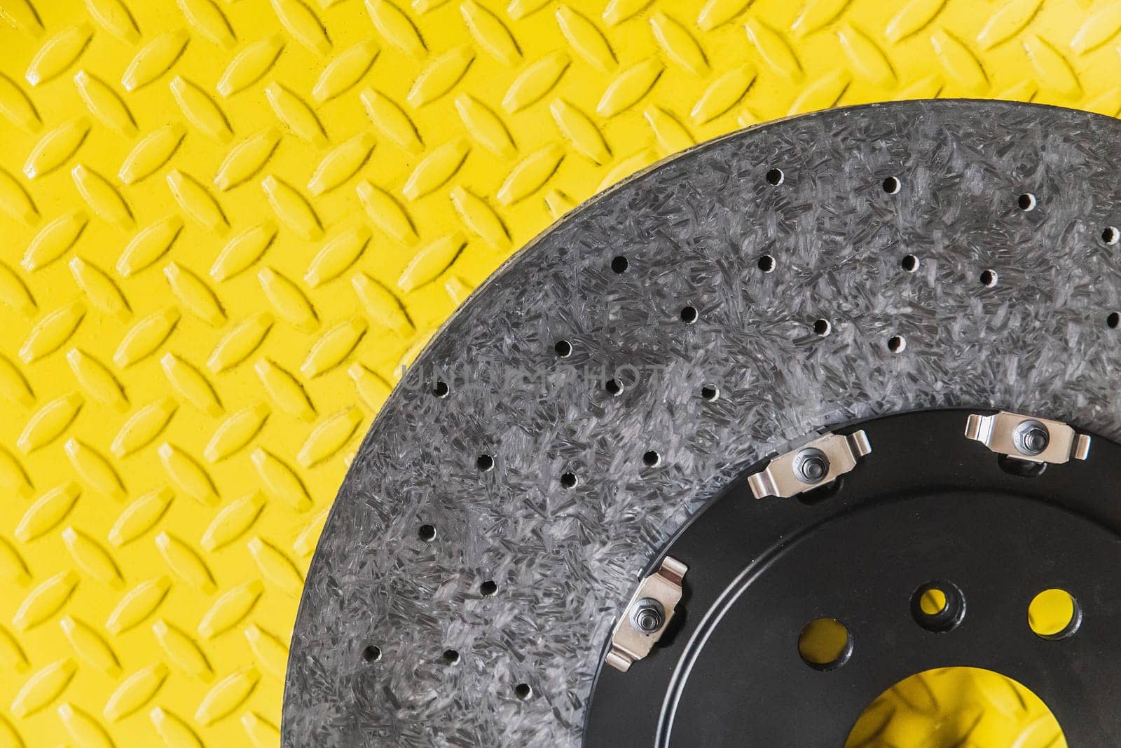 new carbon brake disc on yellow background.
