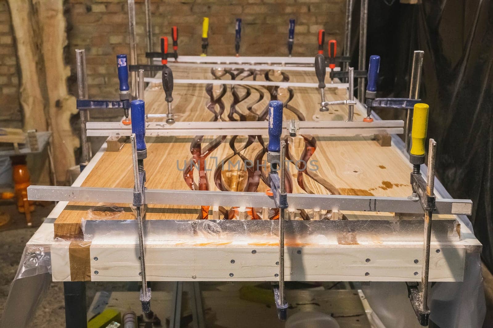 Making a dining table by oak and epoxy resin in the workshop.