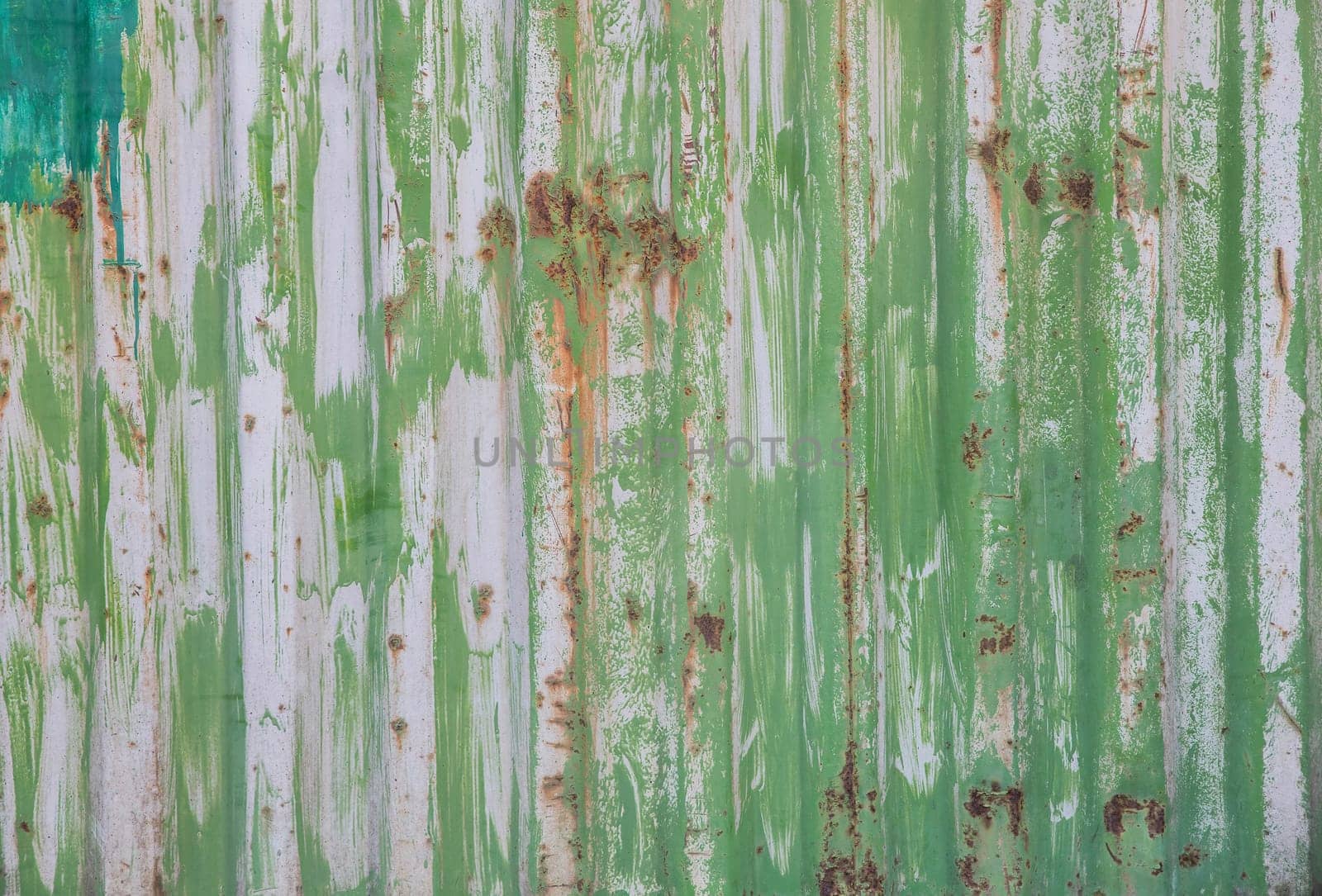 green rusty striped wall of metal container.