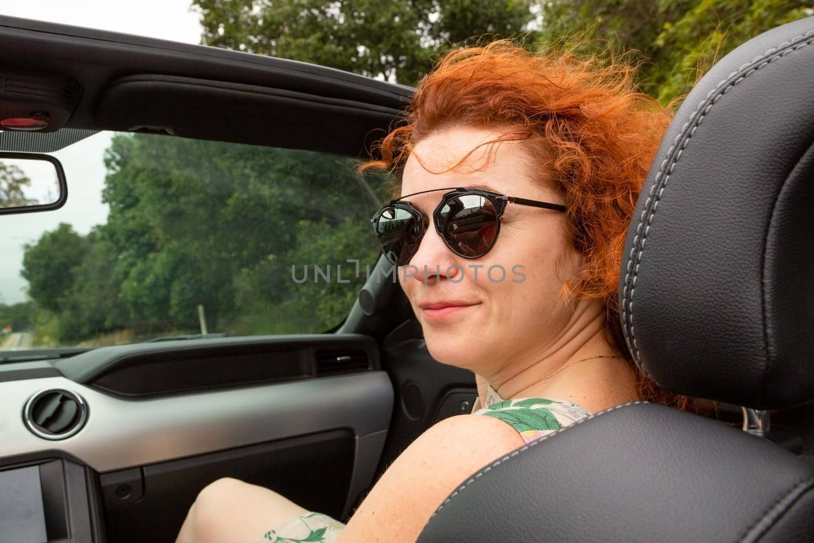 Woman Passenger On Road Trip In Convertible Car by Sid10
