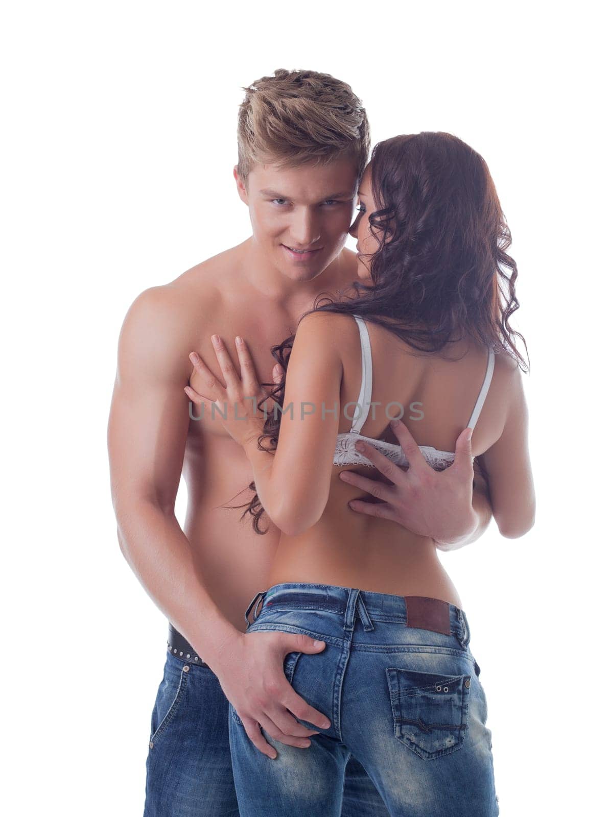 Attractive young guy hugging curly girl in studio, close-up