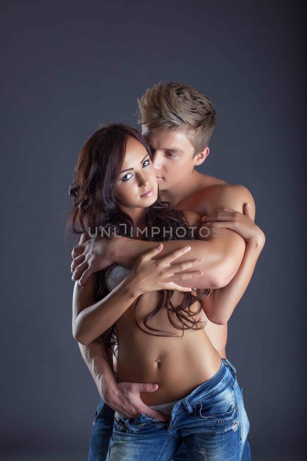 Portrait of passionate lovers posing in studio, close-up