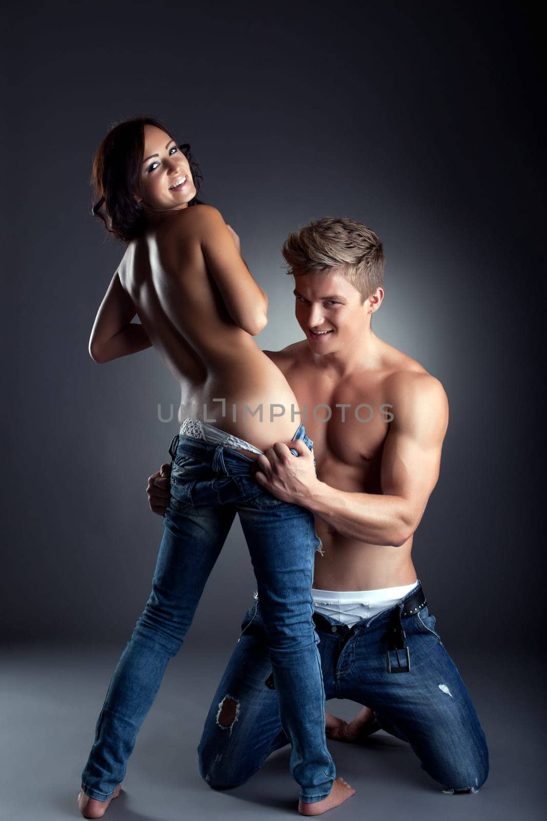 Couple of playful young people undresses at camera by rivertime