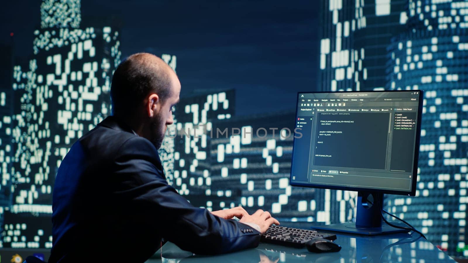 Businessman working on computer in skyscraper office, checking information on monitor in department space. Corporate employee sitting at desk in high end building, urban city lights.