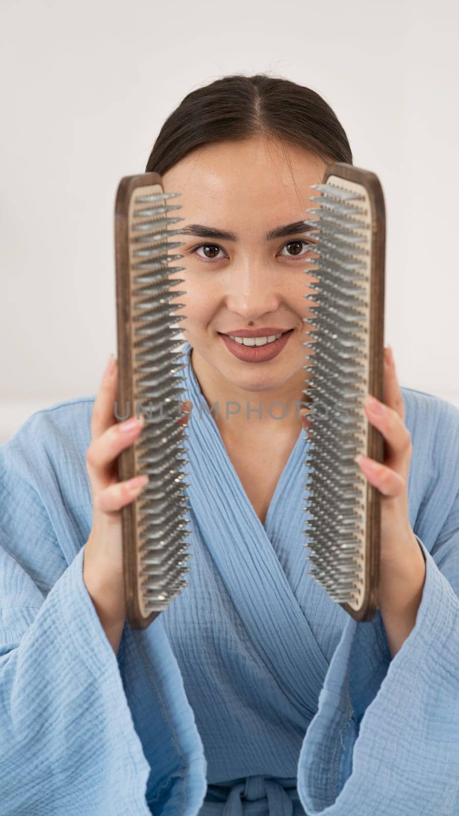 Asian woman holding sadhu boards on face background