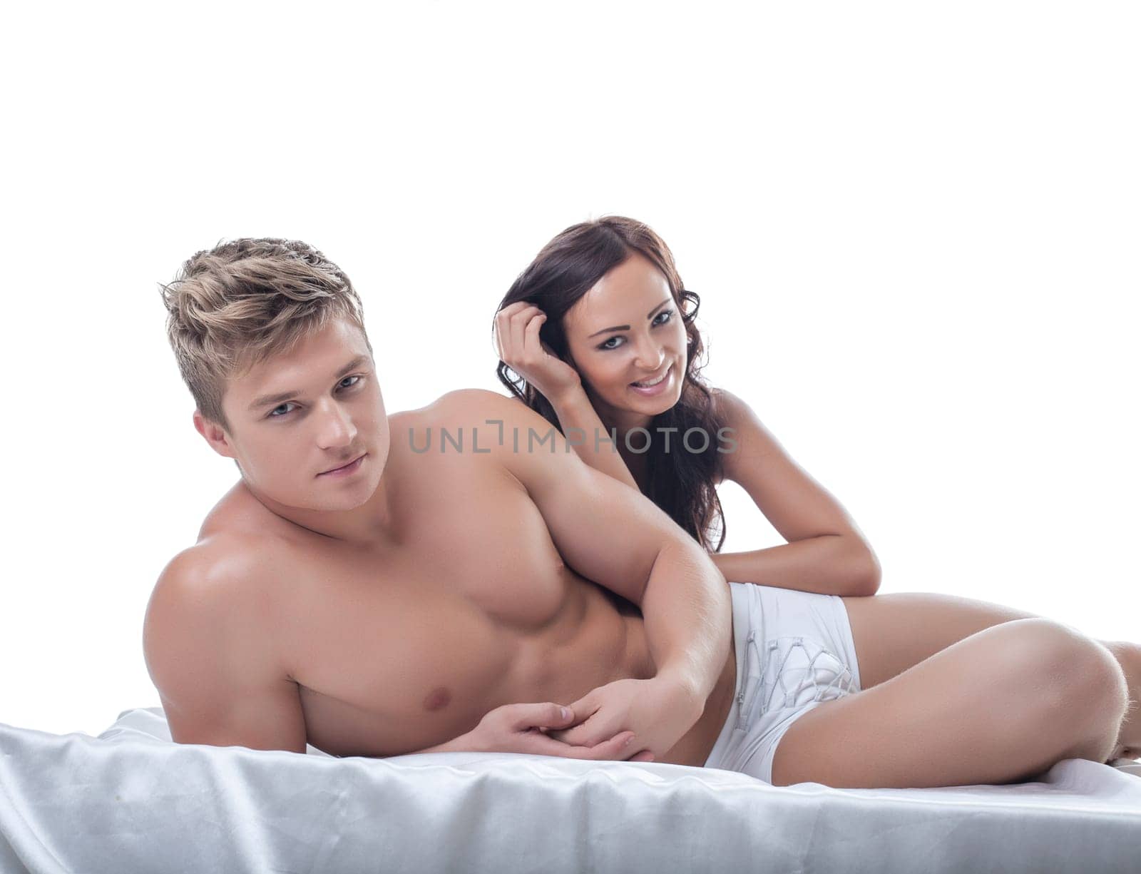 Image of pretty young couple posing in bed, close-up