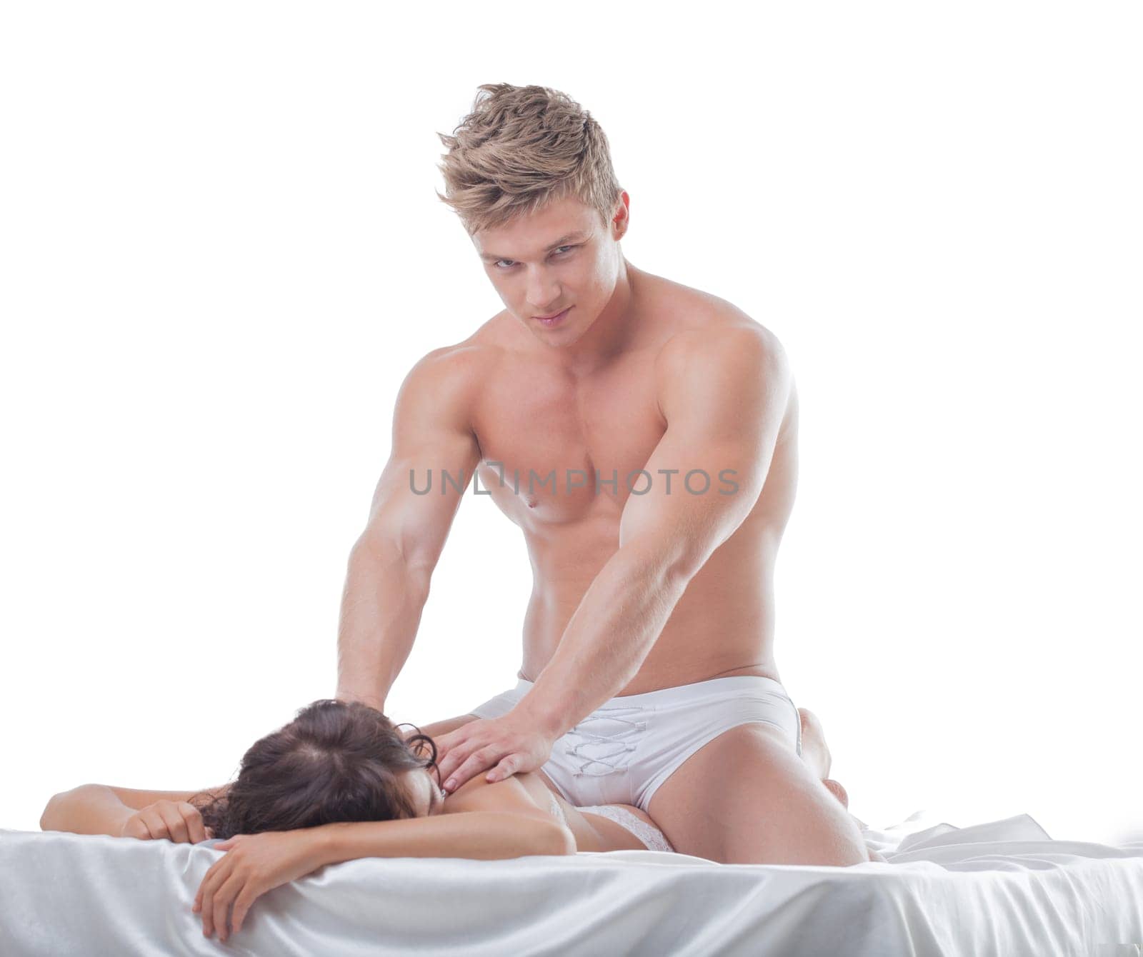 Attractive muscular guy massaging girl's back, isolated on white