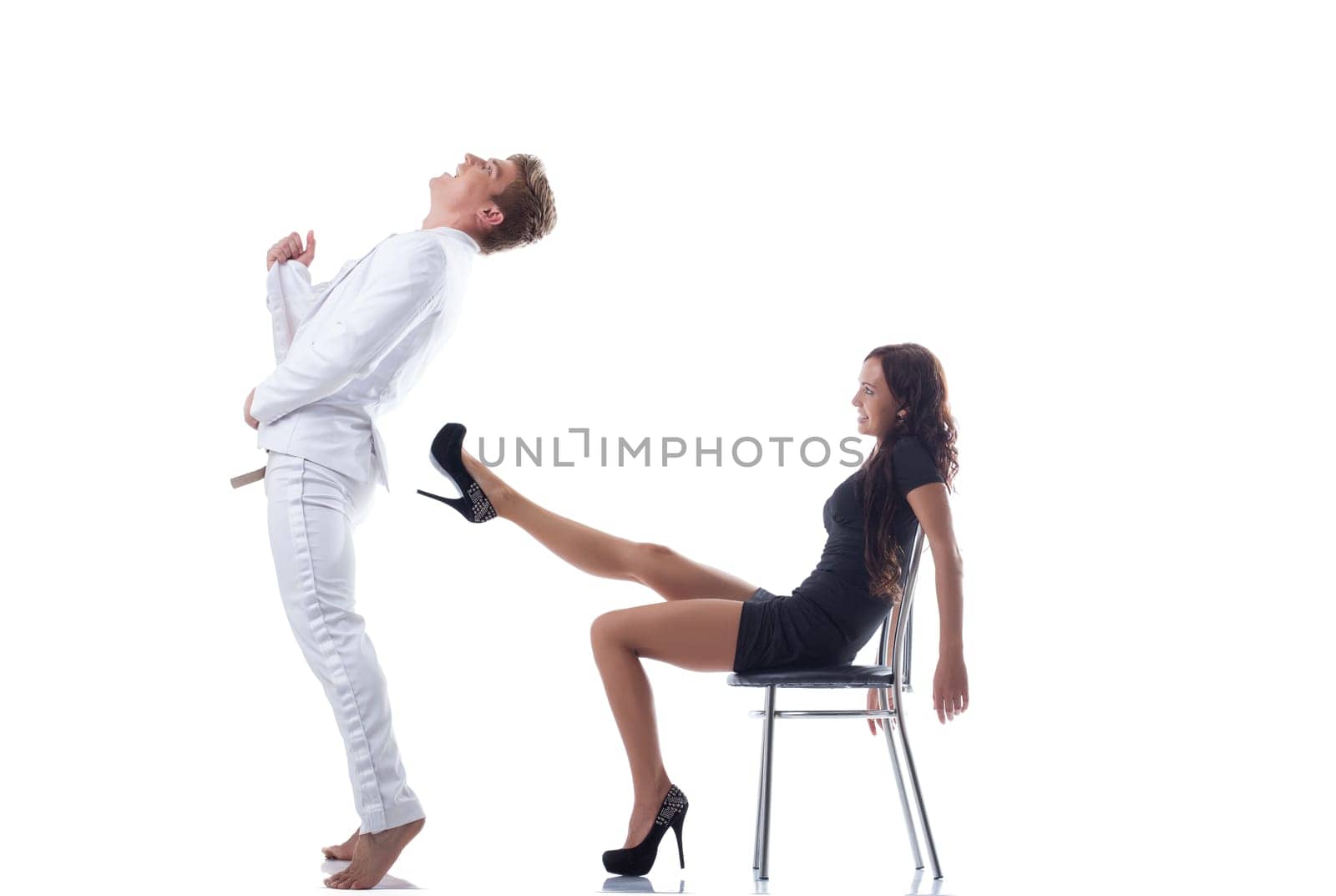 Attractive young couple having fun in studio, isolated on white