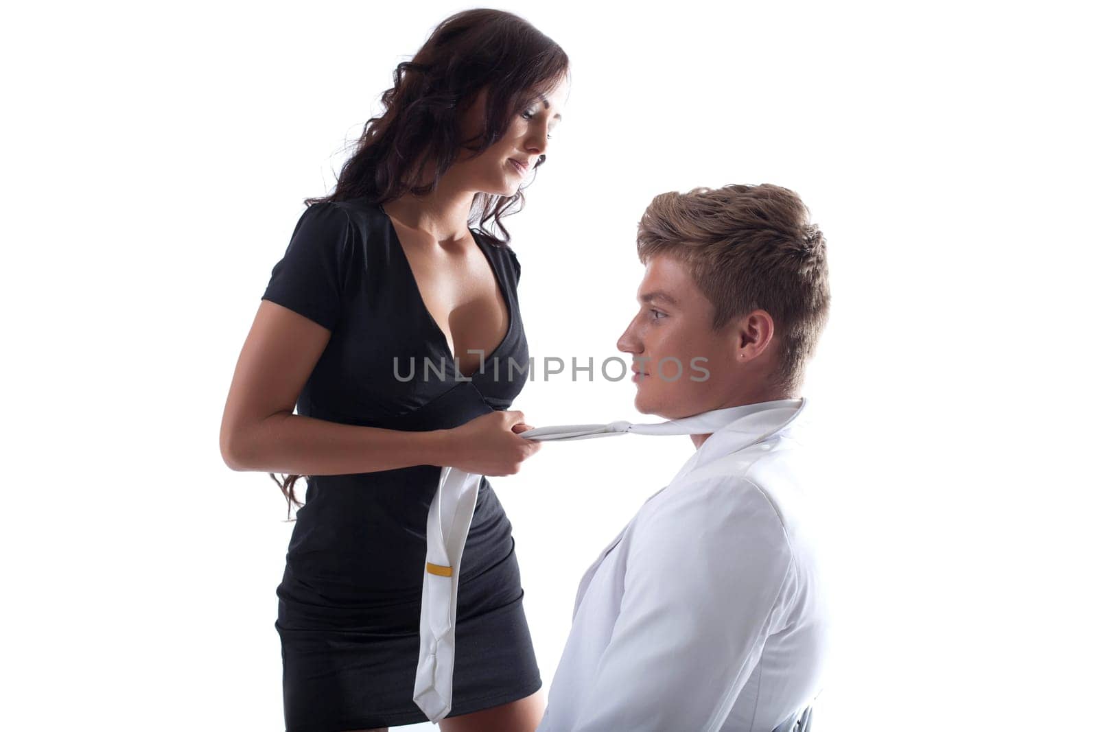 Attractive sensual lovers posing at studio, isolated on white