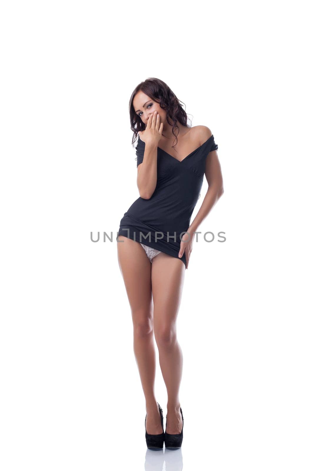 Image of seductive slim model posing in black tunic, isolated on white
